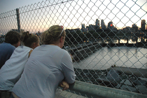 Onlookers gather on an adjacent bridge to view the devastation of the I-35W bridge collapse in Minneapolis