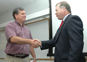 Associate Professor Jim Stiles is congratulated by KU Endowment President Dale Seurferling