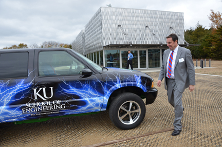 Mark Reuss prepares to take a ride in a '97 GMC Jimmy that was converted to an electric vehicle by the KU EcoHawks.