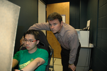Paul Atchley observes a student in a driving simulator