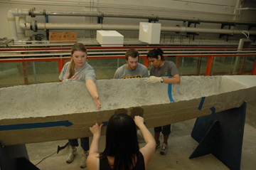 Students at work on their concrete canoe