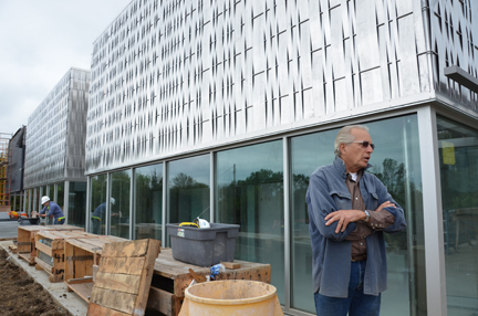 Architecture Professor Dan Rockhill stands outside the building created by his students for the EcoHawks endeavor.