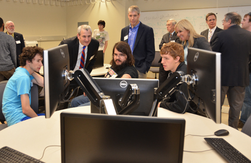 Dean of Engineering Michael Branicky and Garmin President and CEO Cliff Pemble talk with CS students about their capstone project in the new Min Kao Engineering Design Studio