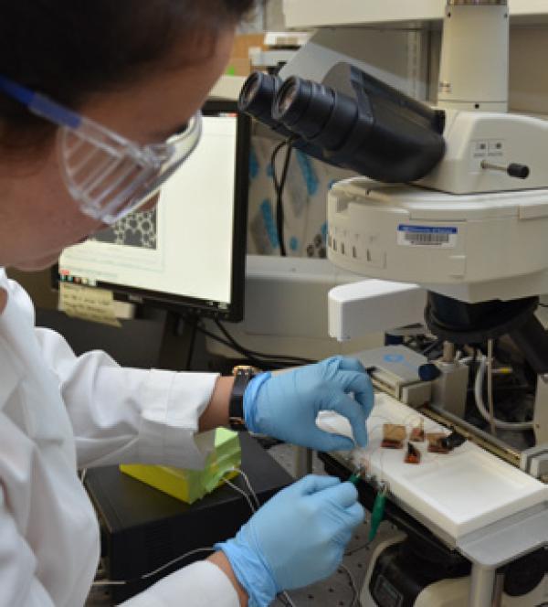 a person with goggles working with samples
