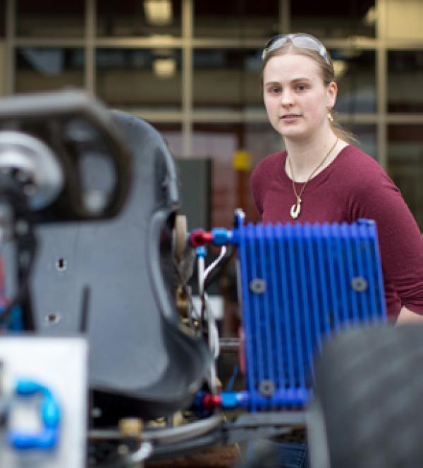 A student looking at an engine