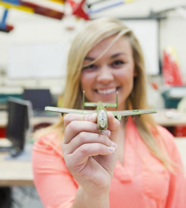a woman holds a toy plane