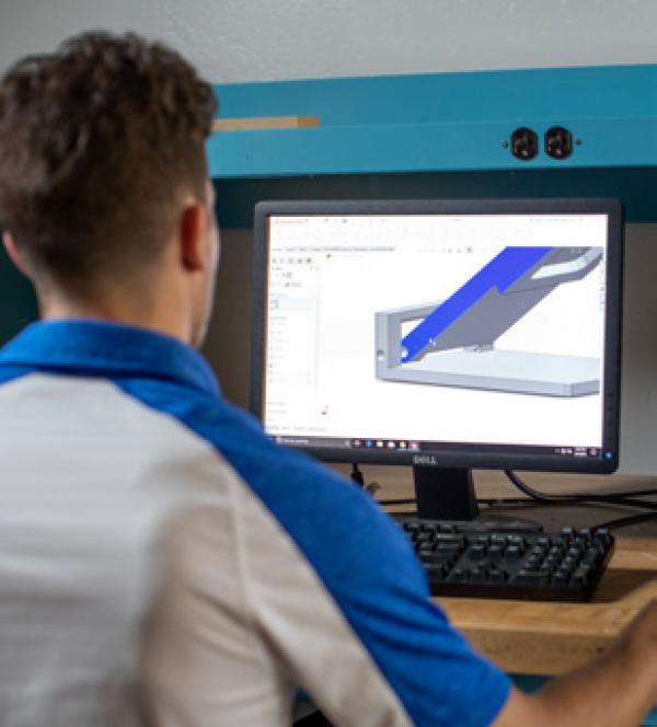 a student looking at a rendering on a computer